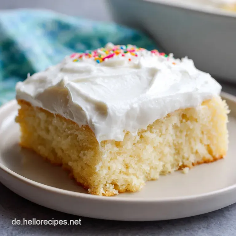 A slice of layered cake on a white plate, showing a bright red glaze, velvety vanilla cream, and fluffy yellow sponge